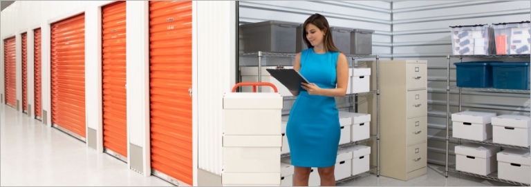 A woman taking inventory of a self storage container