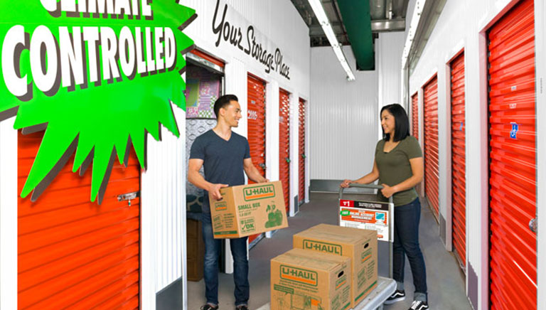 A couple loading boxes into a business storage unit