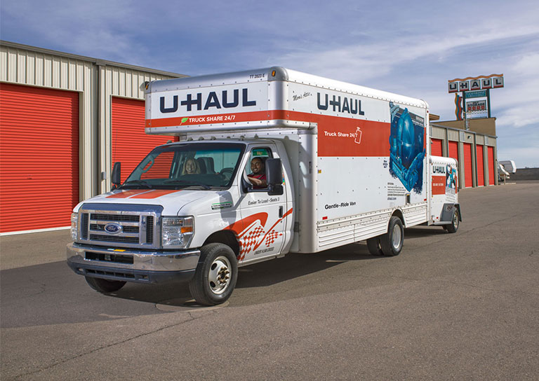 A U-Haul rental truck in front of a business storage facility