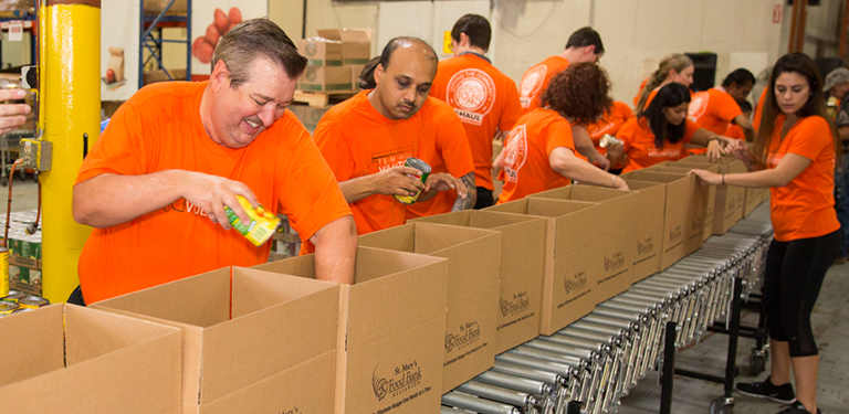 U-Haul employees filling boxes at a food bank