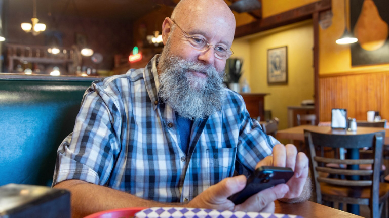 Man sitting and using the U-Haul App
