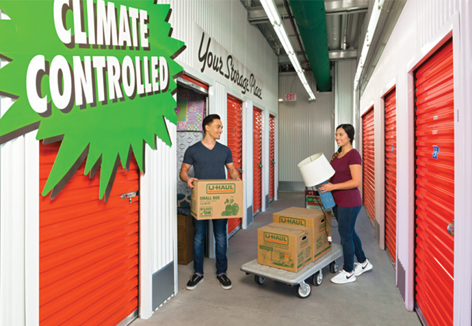 Couple loading household items into a storage unit