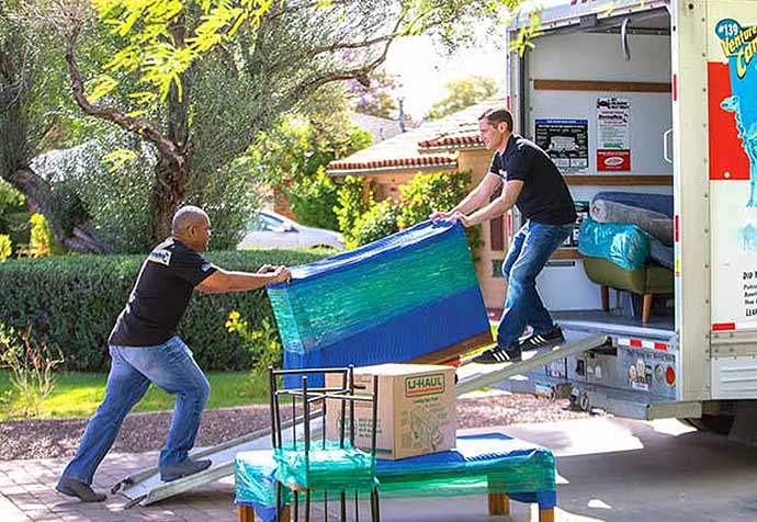 Moving Help® Service Providers loading furniture into a U-Haul moving truck