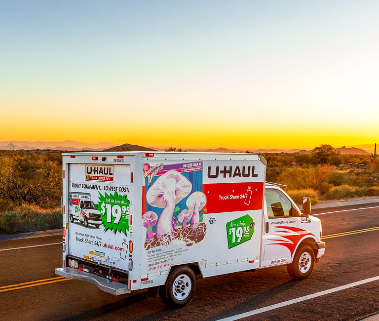 A U-Haul Moving Truck driving on a road in the desert