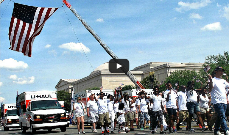 A group of U-Haul employees marching in a local Veterans Day Parade