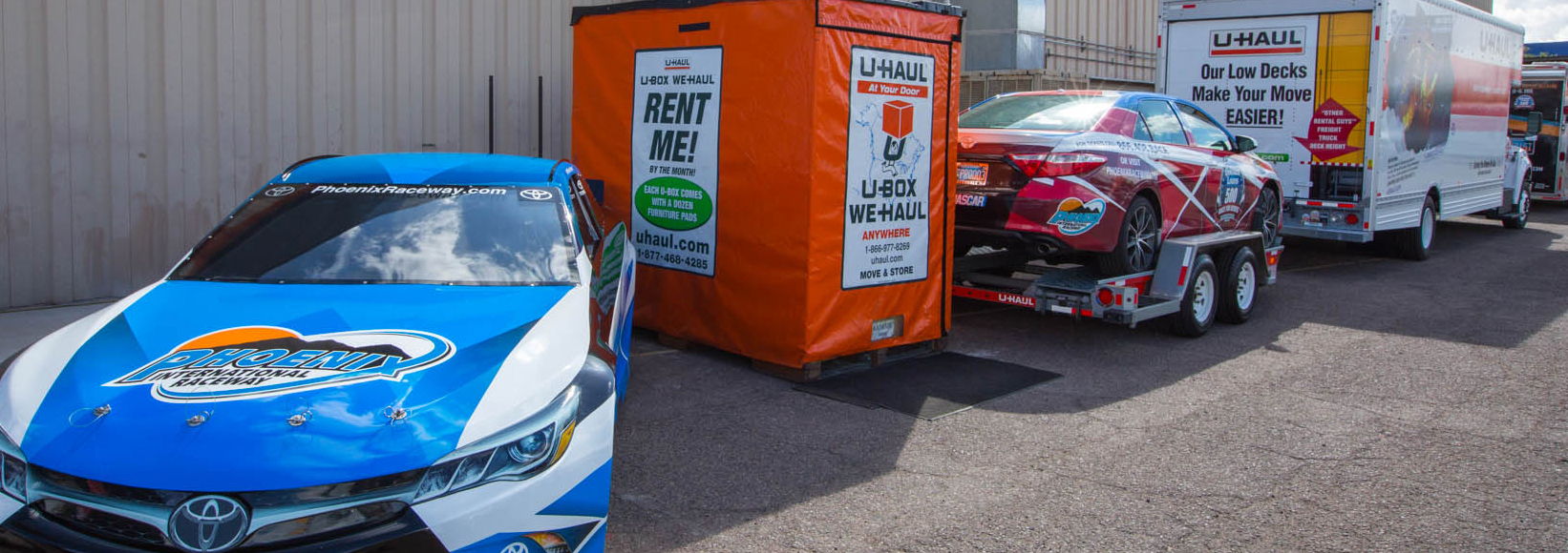 Nascar race cars next U-Haul trucks, trailers and U-Box containers