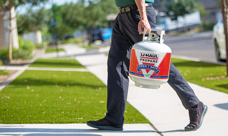 A man delivering a propane tank
