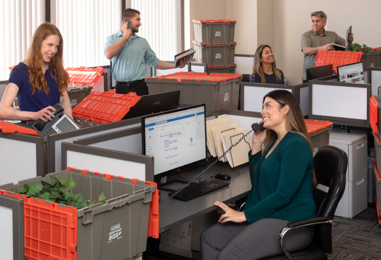 3 stacked plastic moving boxes