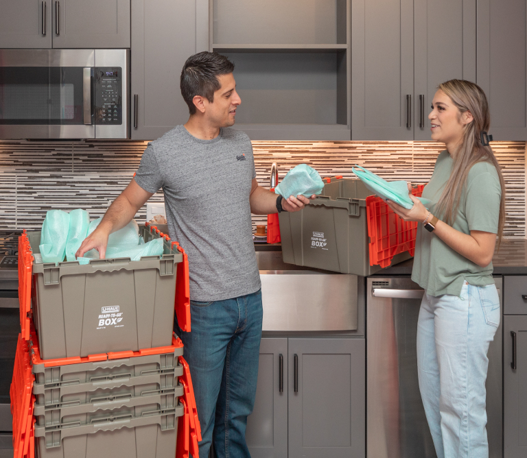 Couple Unpacking Ready-To-Go Boxes