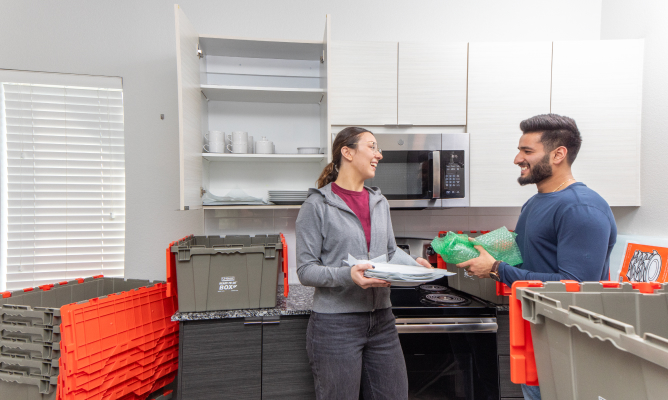 Couple Unpacking Ready-To-Go Boxes