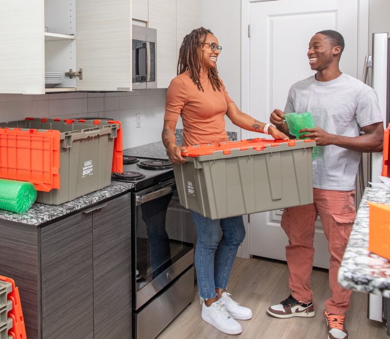 Couple Unpacking Ready-To-Go Boxes