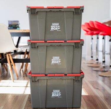 3 stacked plastic moving boxes