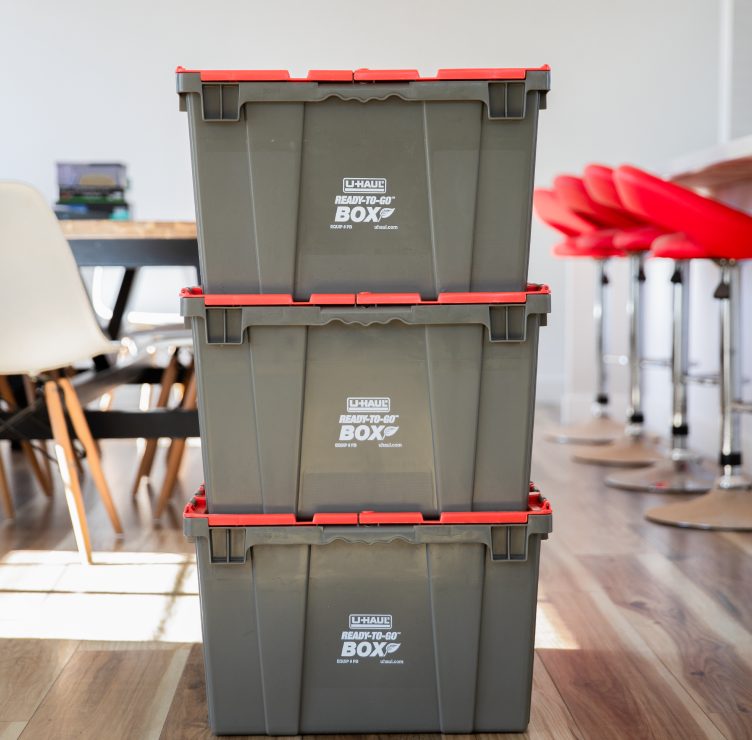 3 stacked plastic moving boxes