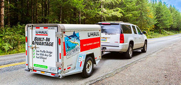 An SUV towing a U-Haul Cargo Trailer
