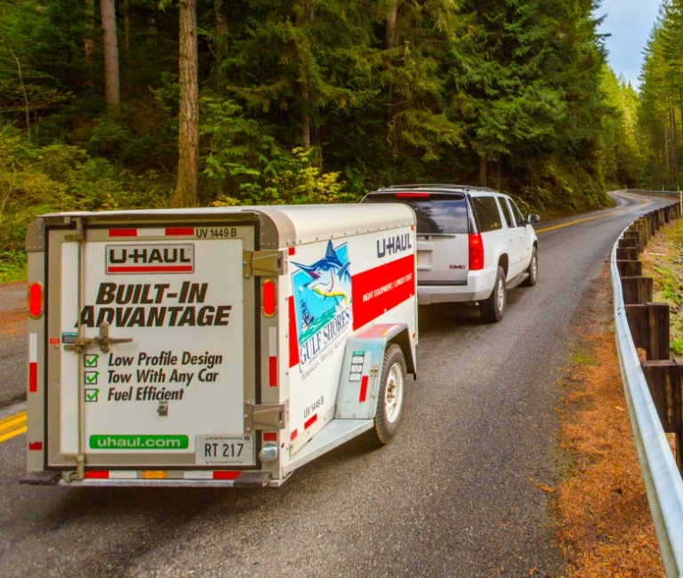 SUV pulling U-Haul cargo trailer