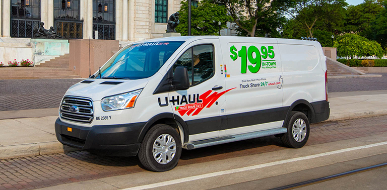 A U-Haul cargo van parked on the street