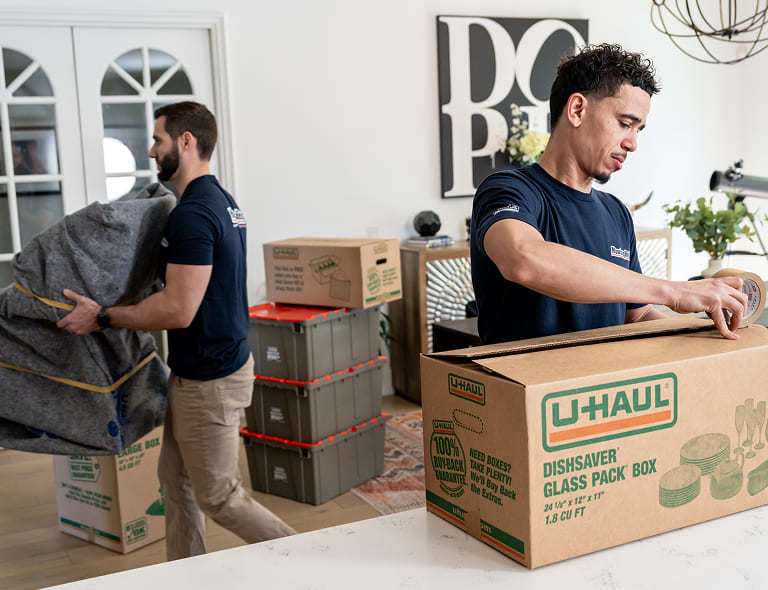 Moving Help crew packing belongings into boxes in a customer's home