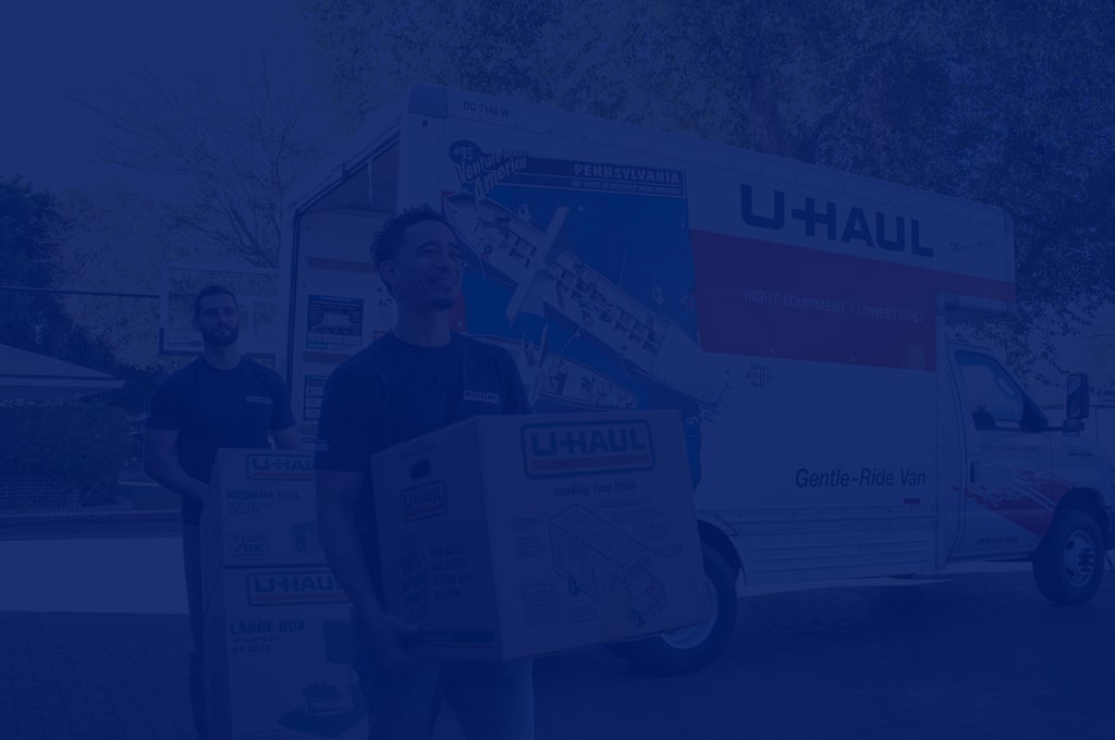 Moving Helpers moving boxes from a U-Haul moving truck