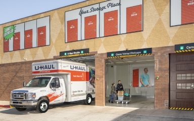 U-Haul rental truck backed up to a U-Haul storage facility