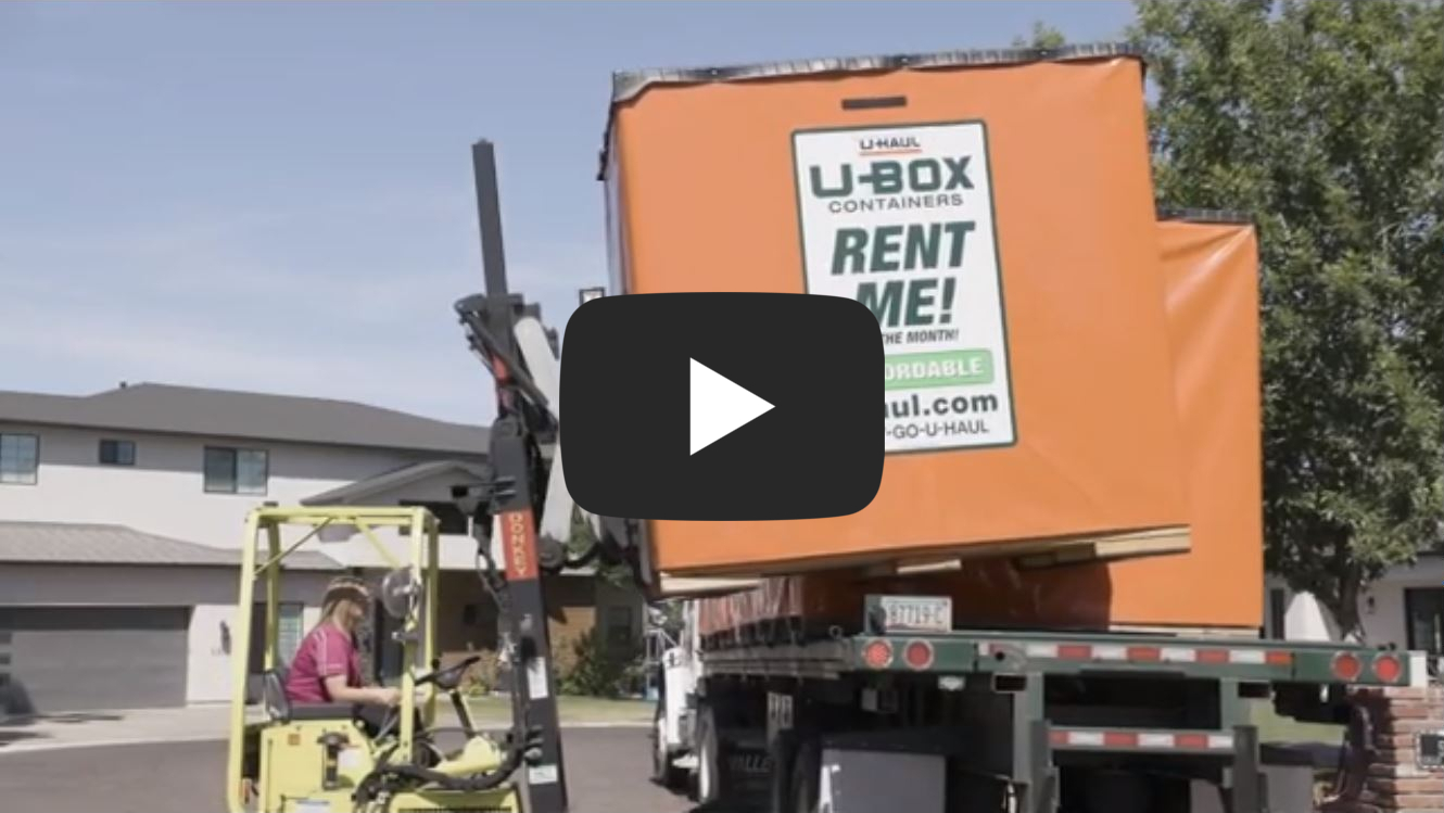 Forklift loading a UBox on a trailer