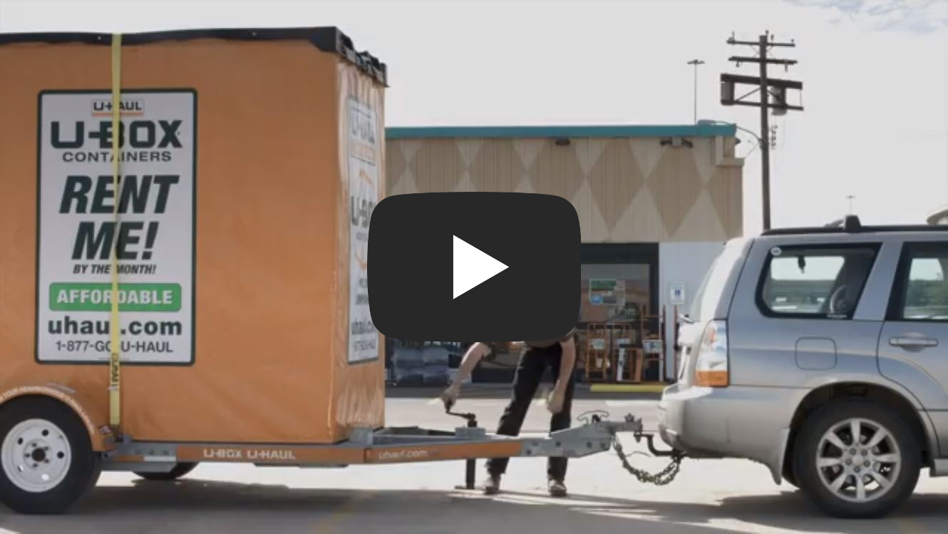 Man attaching trailer to hitch