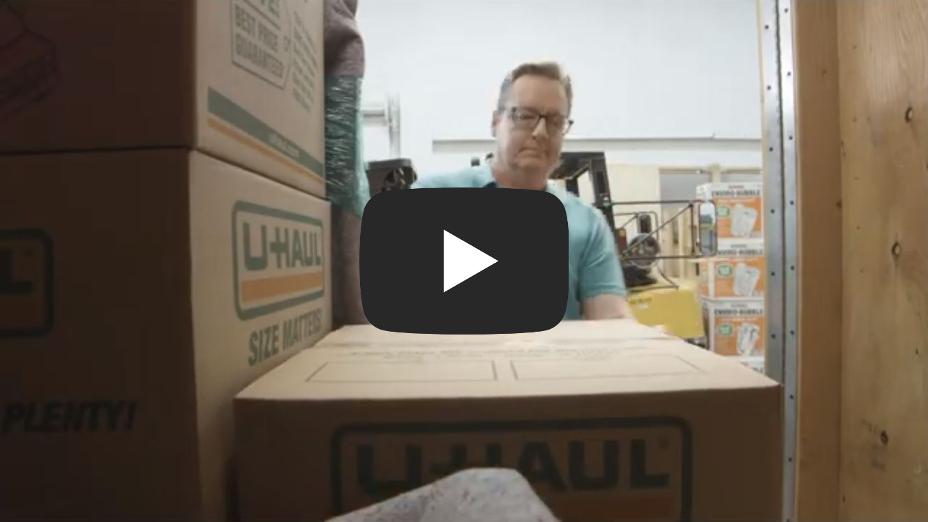 Man loading box into storage unit