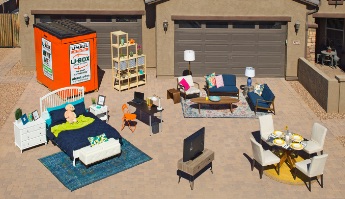 UBox on a driveway with bedroom set, kitchen table, chairs, and living room set
