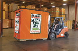 A couple standing beside a U-Haul Portabe Storage Container