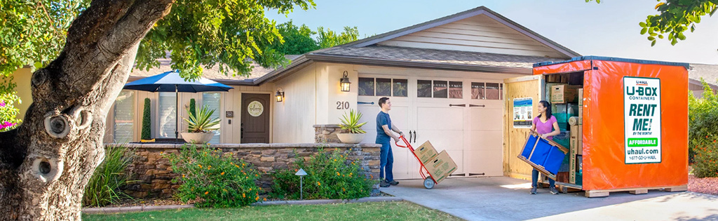 Couple loading a U-Box Container in their driveway