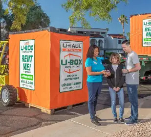 Couple standing in front of their U-Box Container