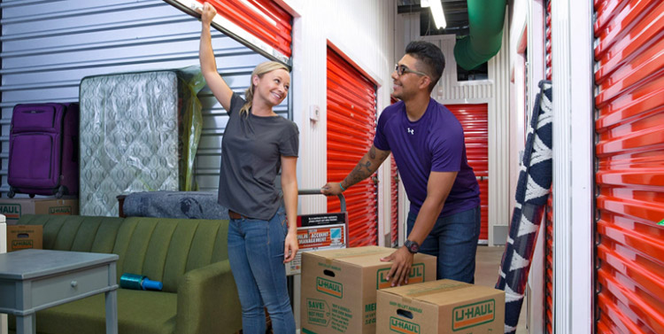 Couple loading a U-Haul storage unit